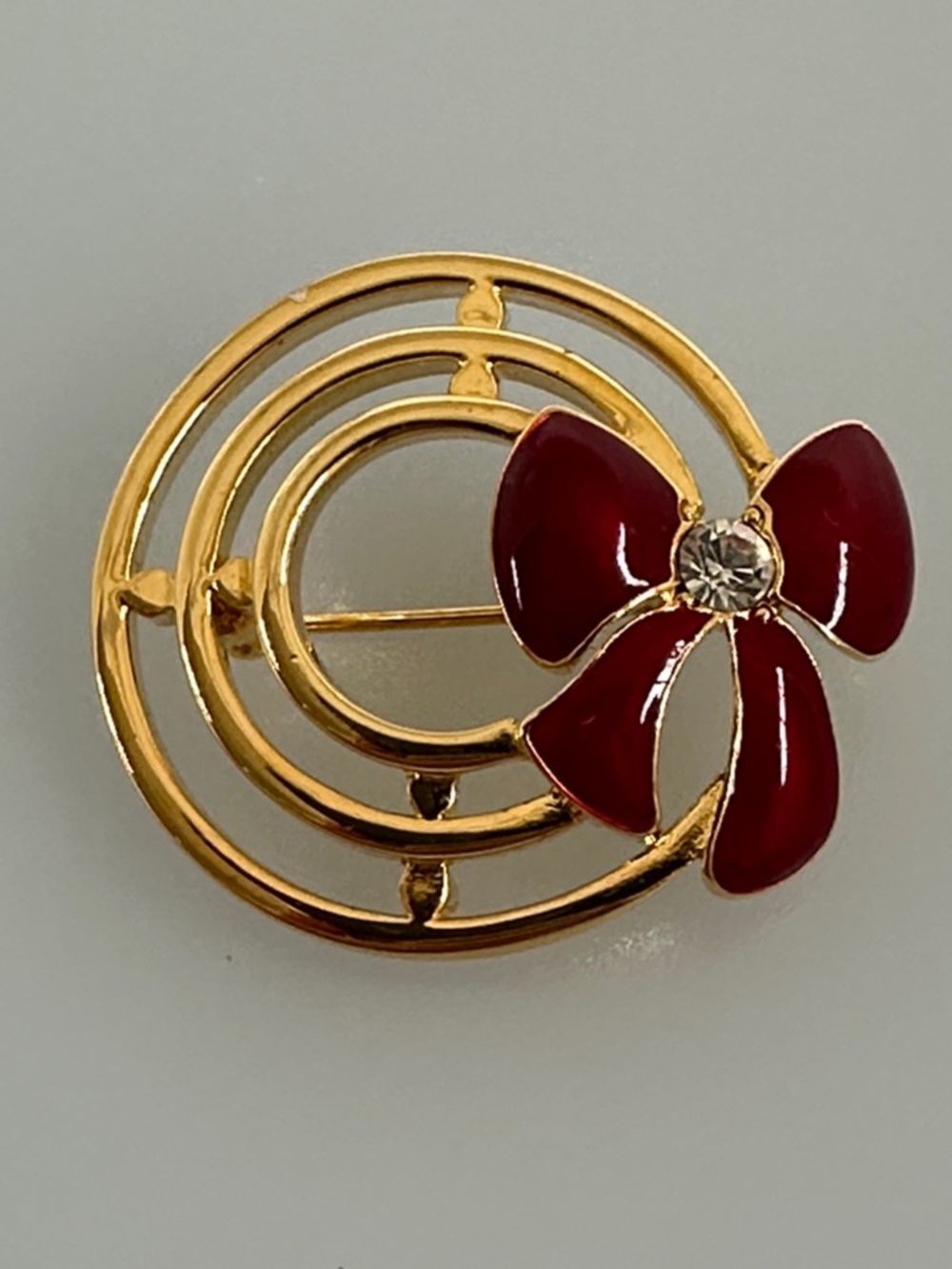 Gold-Tone Brooch with Red Enamel Bow and Crystal Accent